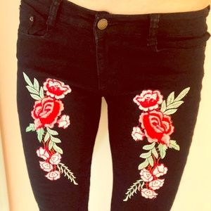 Worn once Black jeans with roses and slits at knee